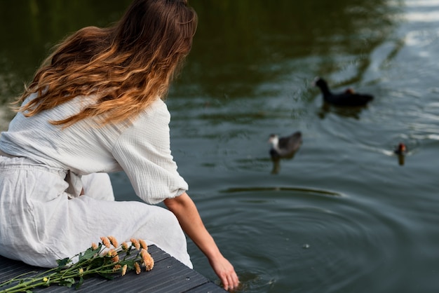 Free photo medium shot woman by the lake