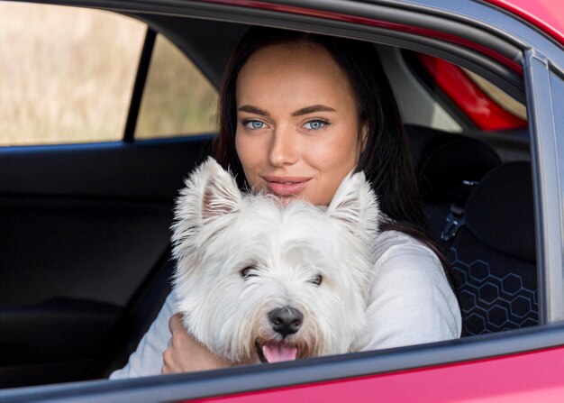 Medium shot woman in car with dog