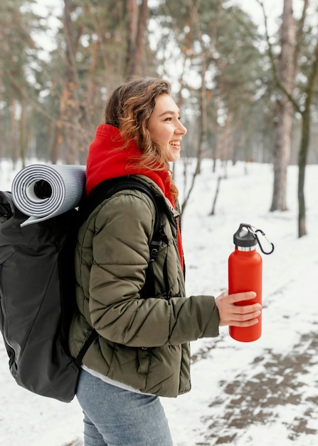 Free Photo medium shot woman carrying backpack