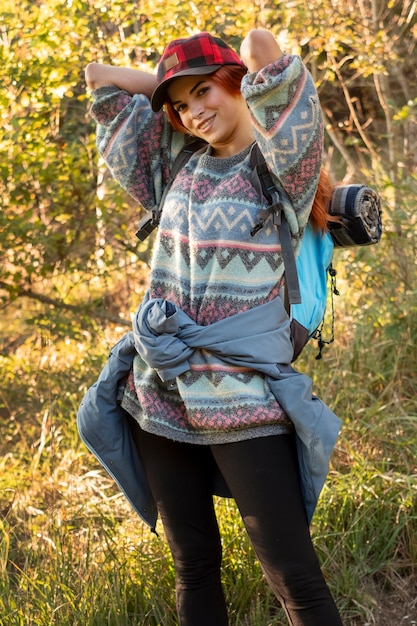 Free photo medium shot woman carrying backpack