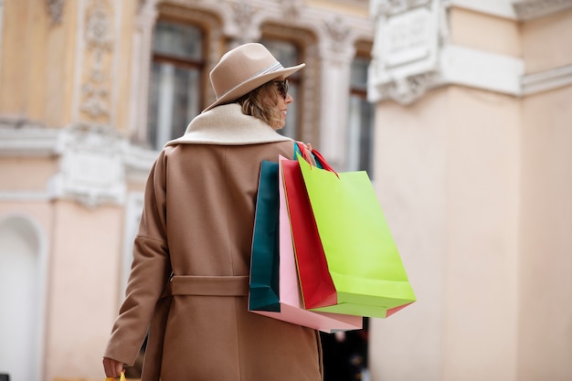 Medium shot woman carrying bags