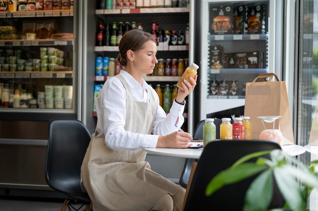 Free Photo medium shot woman checking product