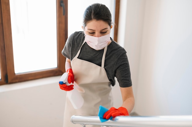 Medium shot woman cleaning railing