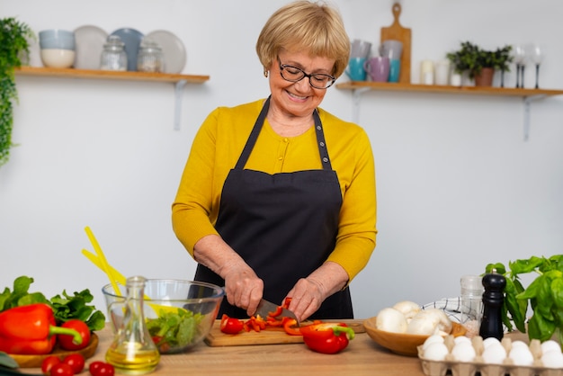 Free photo medium shot woman cooking at home