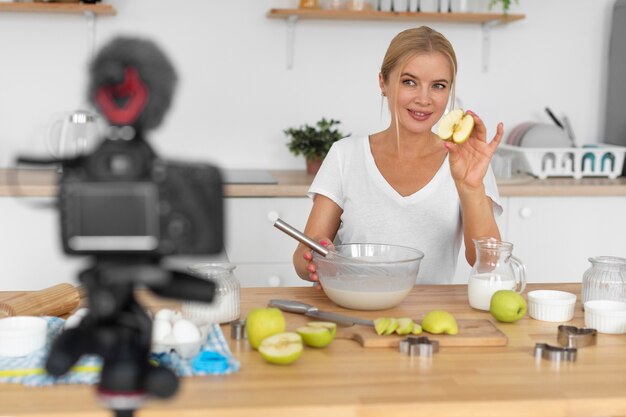 Medium shot woman cooking with apples