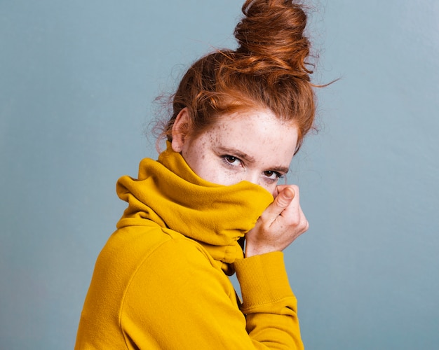 Free Photo medium shot woman covering her face with hoodie