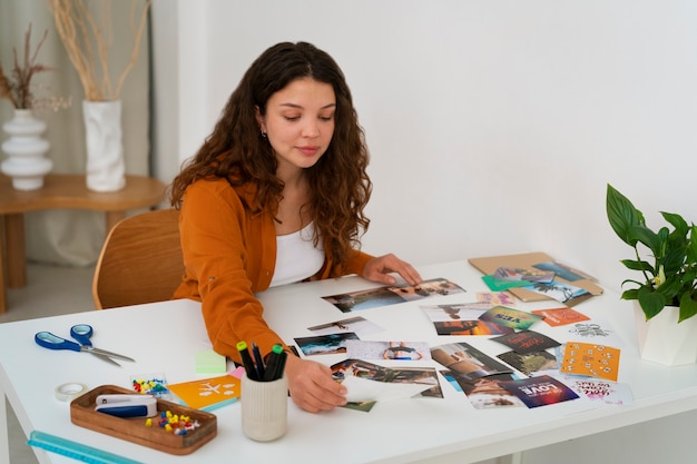 Medium shot woman creating inspiring vision board