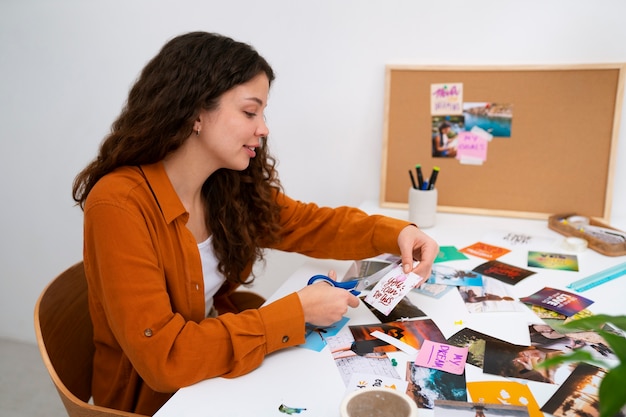 Free photo medium shot woman creating inspiring vision board