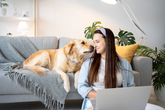 Medium shot woman and cute dog inside