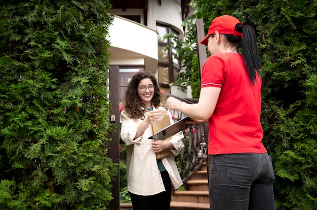 Free photo medium shot woman delivering pack