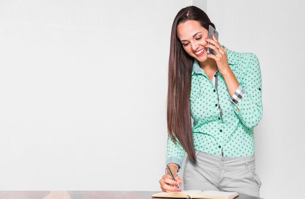 Medium shot woman doing her job at office