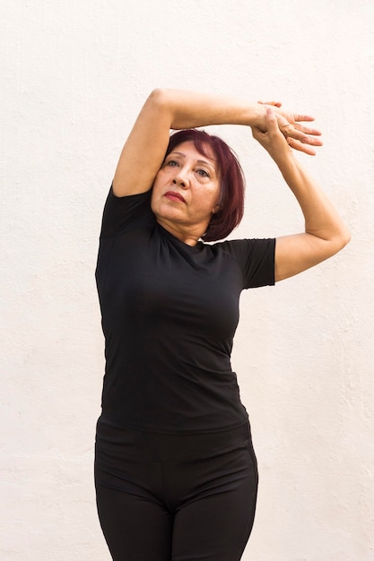 Medium shot of woman doing warm-up exercise