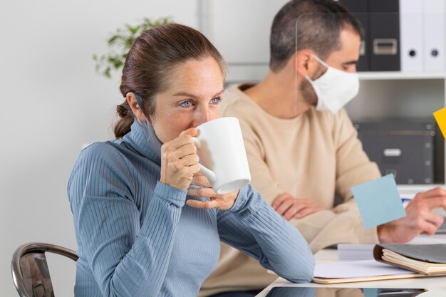 Medium shot woman drinking coffee