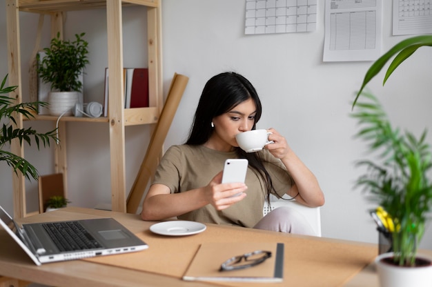 Medium shot woman drinking coffee