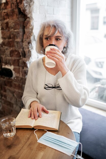 Medium shot woman drinking coffee