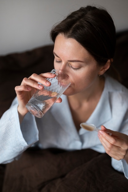 Free Photo medium shot woman drinking water