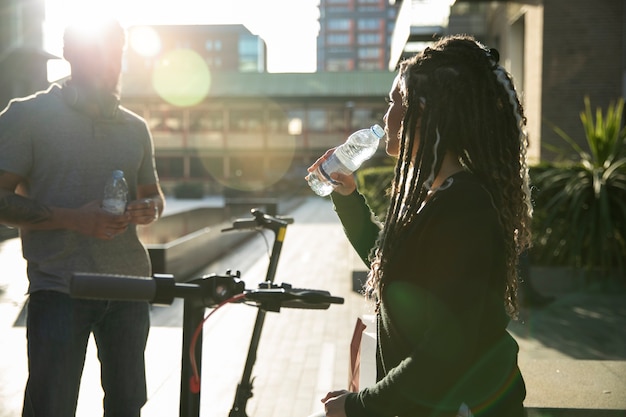 Free photo medium shot woman drinking water