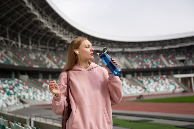 Free Photo medium shot woman drinking water