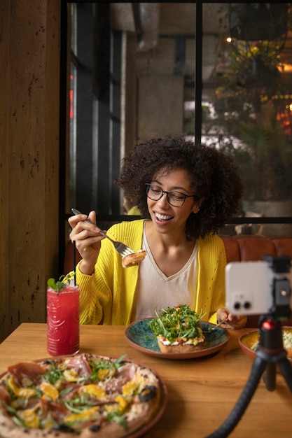 Medium shot woman eating delicious food