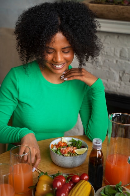 Medium shot woman eating salmon bowl