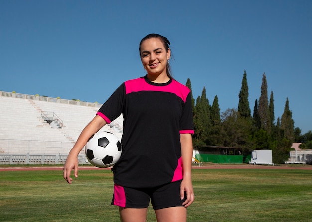 Free photo medium shot woman football player on field