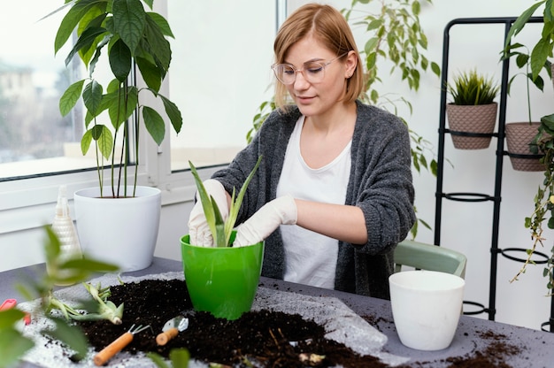 Medium shot woman gardening indoors