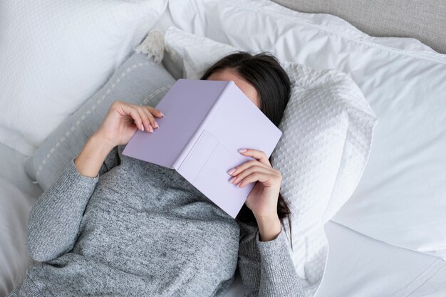 Medium shot woman holding book