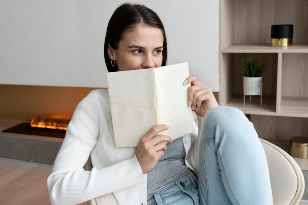 Medium shot woman holding book