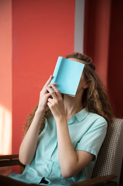 Medium shot woman holding book