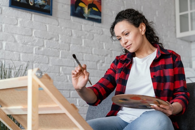 Medium shot woman holding brush