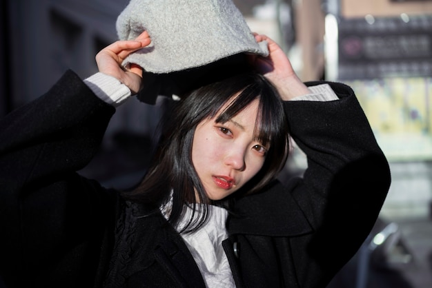 Free photo medium shot woman holding bucket hat