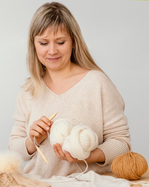 Medium shot woman holding cable needle