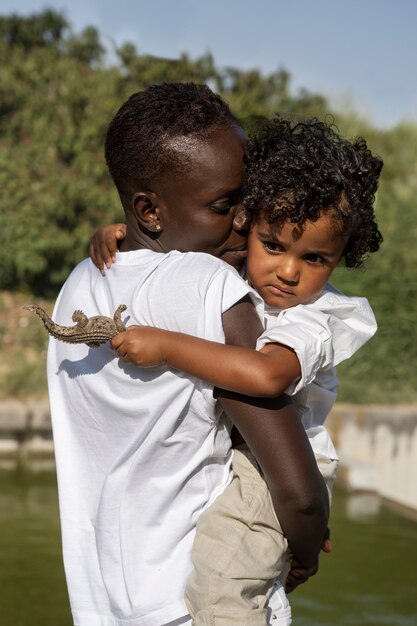 Medium shot woman holding child