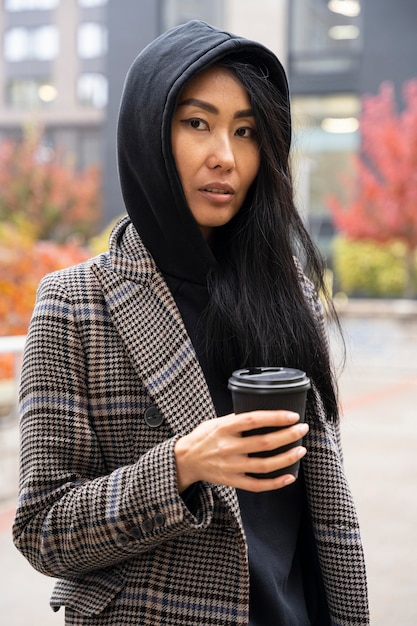 Medium shot woman holding coffee cup