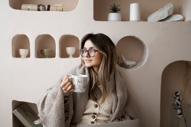 Medium shot woman holding coffee cup