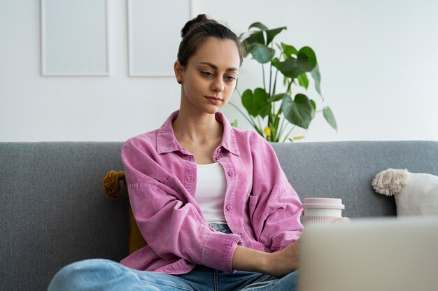 Medium shot woman holding coffee cup