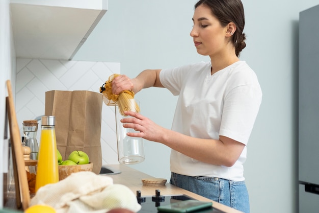 Medium shot woman holding container