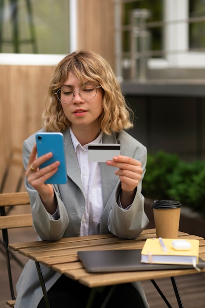 Free Photo medium shot woman holding credit card