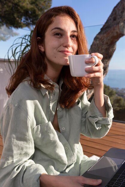 Medium shot woman holding cup