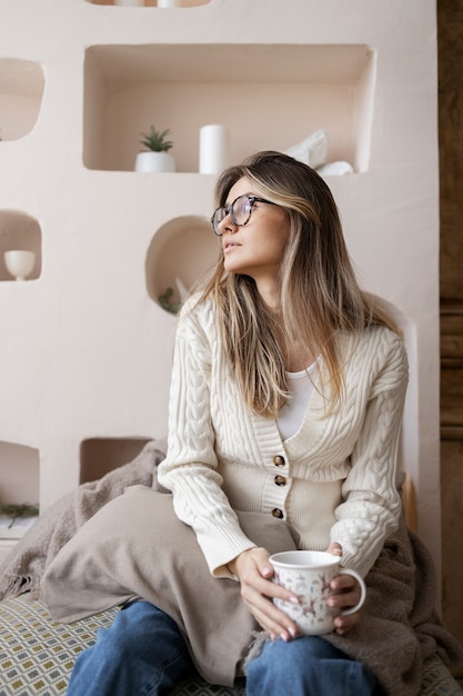 Medium shot woman holding cup