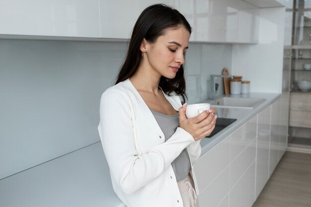 Medium shot woman holding cup