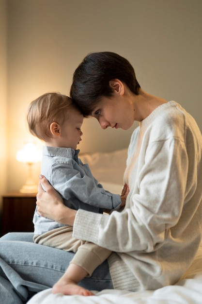 Medium shot woman holding cute baby