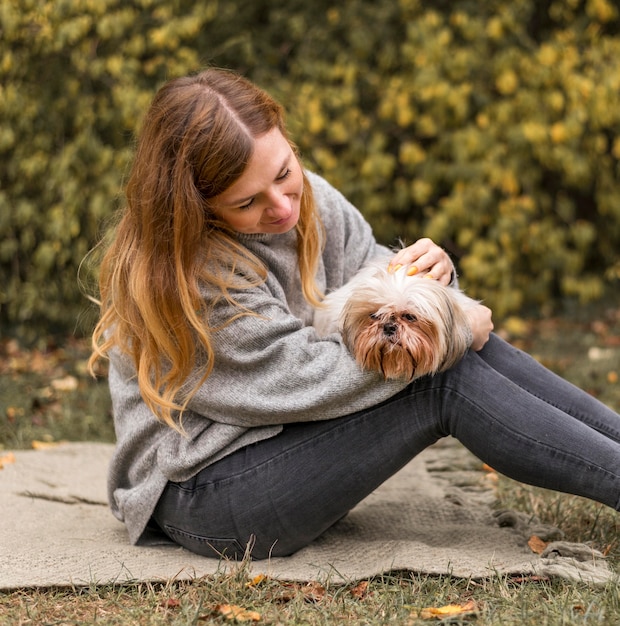 Medium shot woman holding cute dog