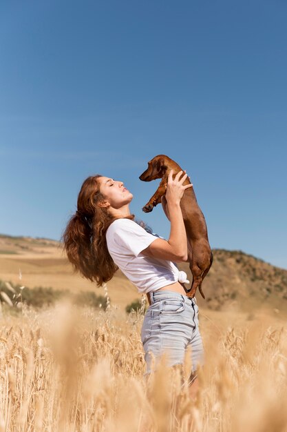 Medium shot woman holding cute dog