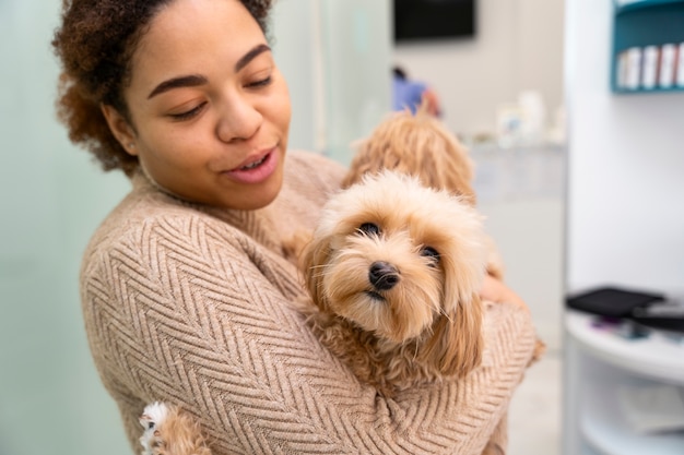 Free Photo medium shot woman holding cute dog