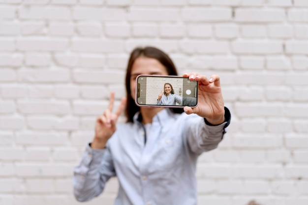 Medium shot woman holding device