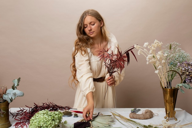 Free photo medium shot woman holding dried plants