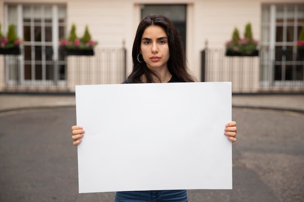 Medium shot woman holding empty placard