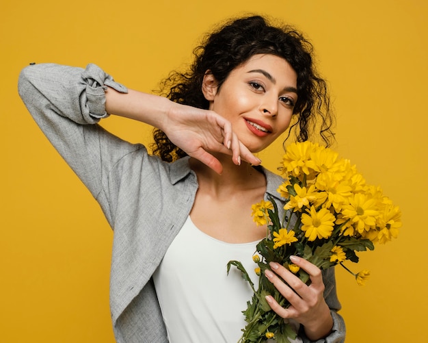 Medium shot woman holding flowers