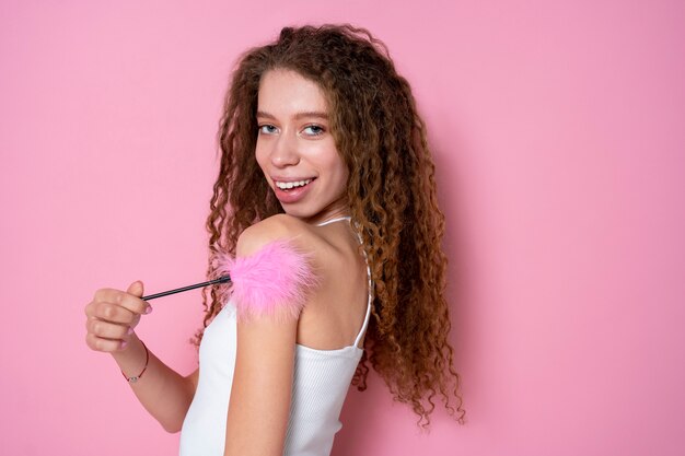 Medium shot woman holding fluffy sex toy